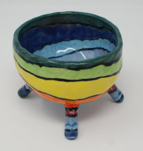 Delightful colourful pinched four legged bowl