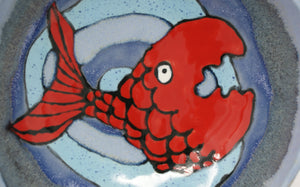 Round three legged bowl with red fish